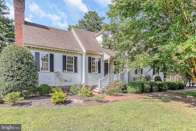 cape cod-style house with a front lawn