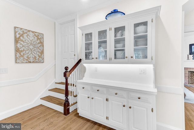 interior space with wood-type flooring and crown molding