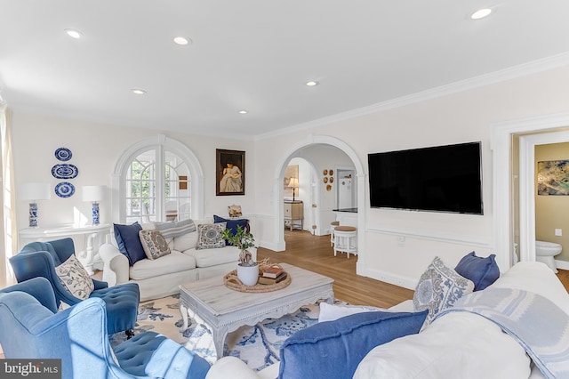 living room featuring crown molding and light hardwood / wood-style floors