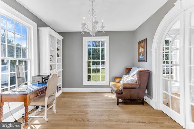 office with a notable chandelier and light hardwood / wood-style floors