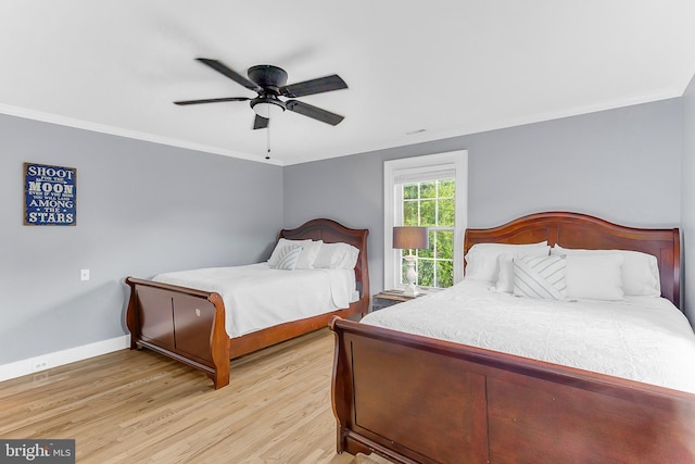 bedroom featuring ornamental molding, light hardwood / wood-style floors, and ceiling fan