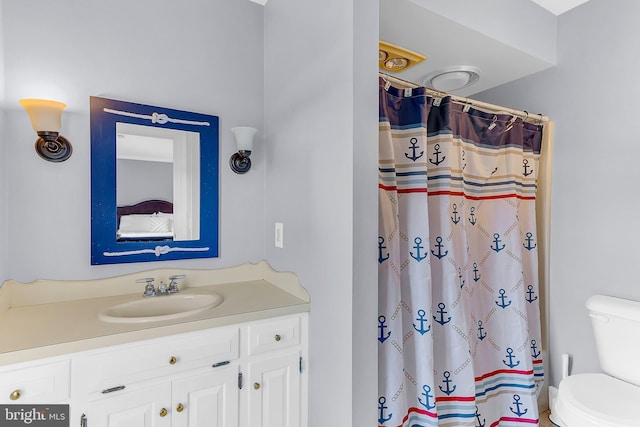 bathroom featuring curtained shower, vanity, and toilet