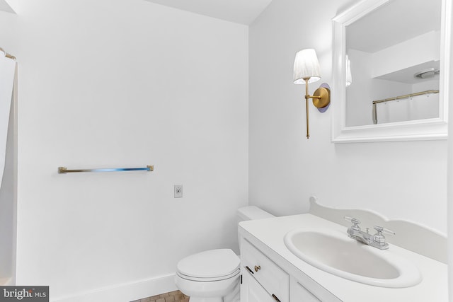 bathroom with vanity, toilet, and tile patterned floors