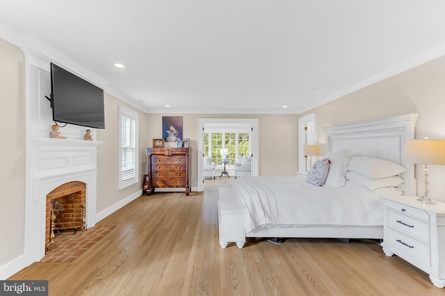 bedroom featuring ornamental molding and light hardwood / wood-style floors