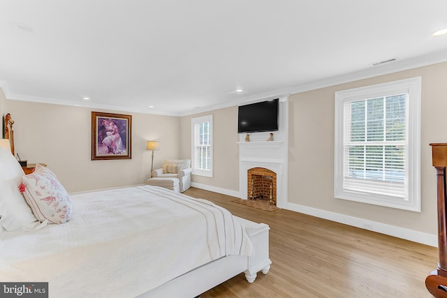 bedroom featuring light hardwood / wood-style floors and crown molding