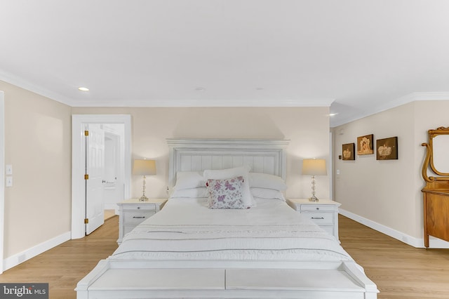 bedroom featuring light wood-type flooring and ornamental molding