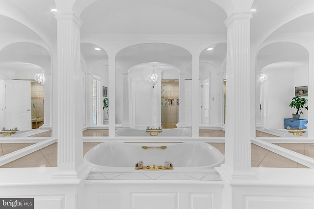 bathroom with independent shower and bath, tile patterned floors, and ornate columns