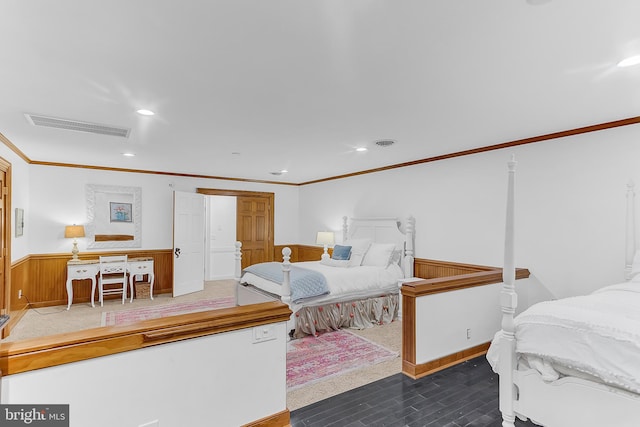 bedroom featuring wooden walls and ornamental molding