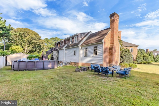 back of house featuring central AC unit and a lawn