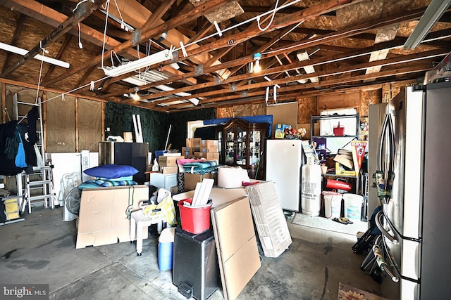 garage with stainless steel refrigerator