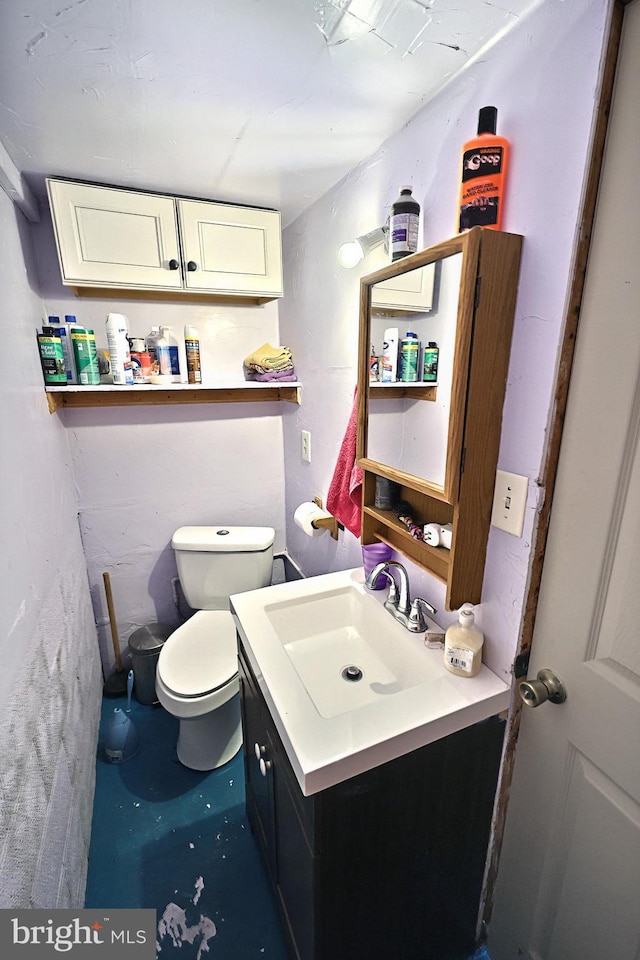 bathroom featuring toilet and vanity