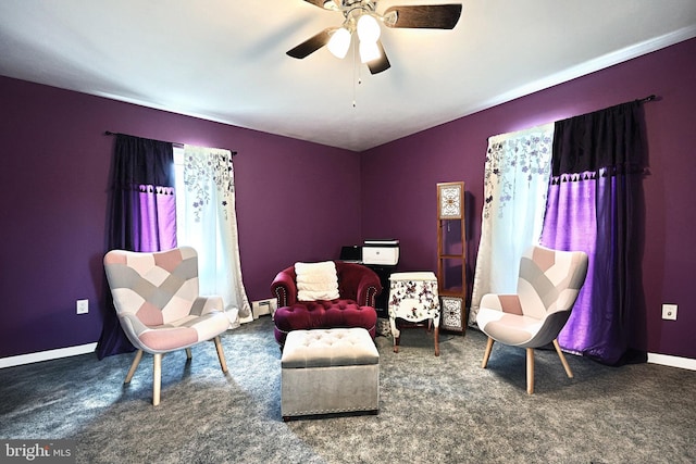 sitting room with carpet flooring, ceiling fan, and a baseboard radiator