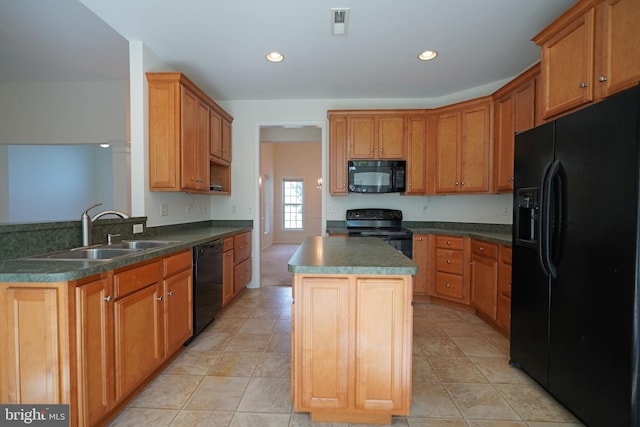 kitchen with black appliances, a kitchen island, light tile patterned flooring, and sink