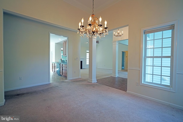 unfurnished dining area featuring carpet flooring, a wealth of natural light, crown molding, and a notable chandelier