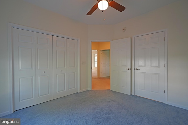 unfurnished bedroom with a closet, ceiling fan, and light carpet