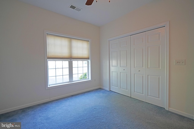 unfurnished bedroom with ceiling fan, a closet, and carpet floors