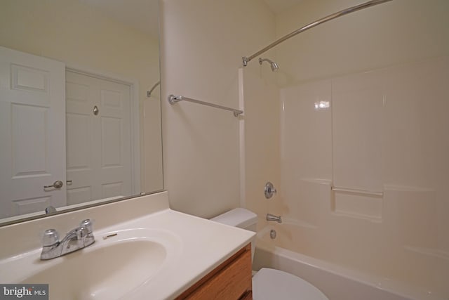 bathroom with washtub / shower combination, vanity, and toilet