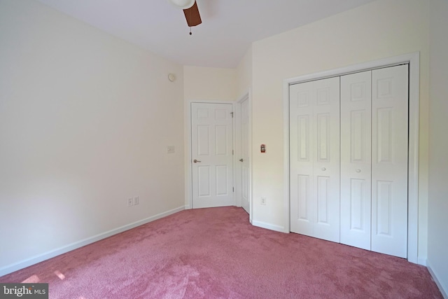 unfurnished bedroom featuring a closet, carpet flooring, a ceiling fan, and baseboards