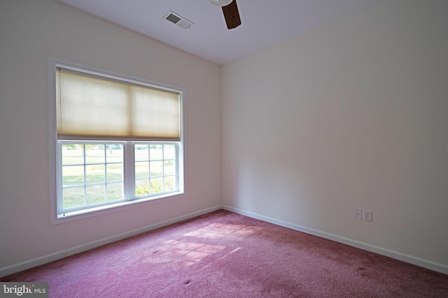 unfurnished room featuring a ceiling fan, carpet, visible vents, and baseboards