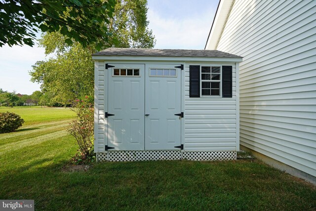 view of outbuilding featuring a yard