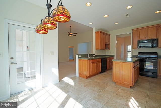 kitchen featuring black appliances, kitchen peninsula, a center island, ceiling fan, and sink