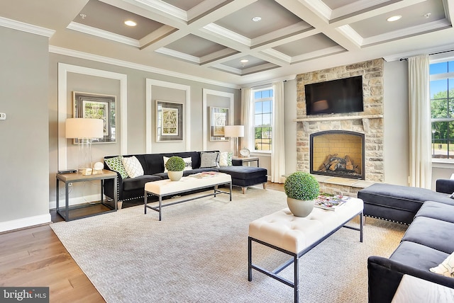 living room featuring hardwood / wood-style floors, coffered ceiling, a healthy amount of sunlight, and a fireplace