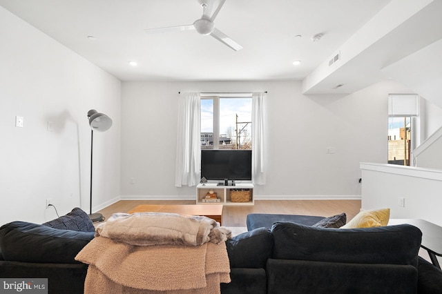 living room with ceiling fan, plenty of natural light, and light hardwood / wood-style floors