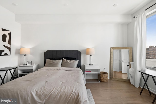 bedroom with hardwood / wood-style floors