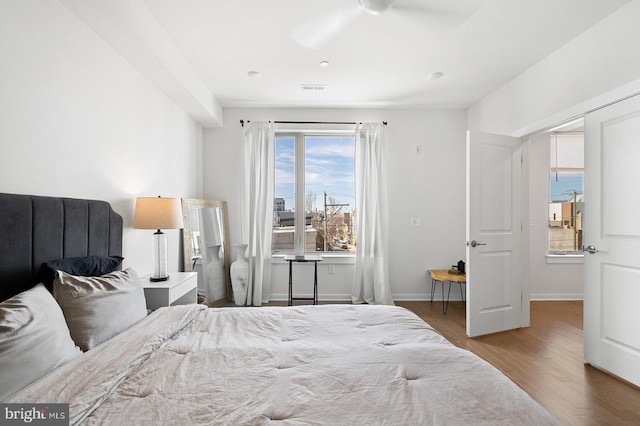 bedroom with ceiling fan and hardwood / wood-style flooring