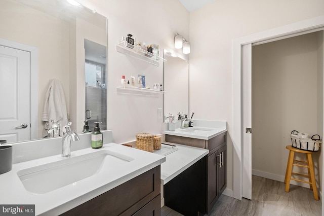 bathroom with vanity, walk in shower, and hardwood / wood-style floors