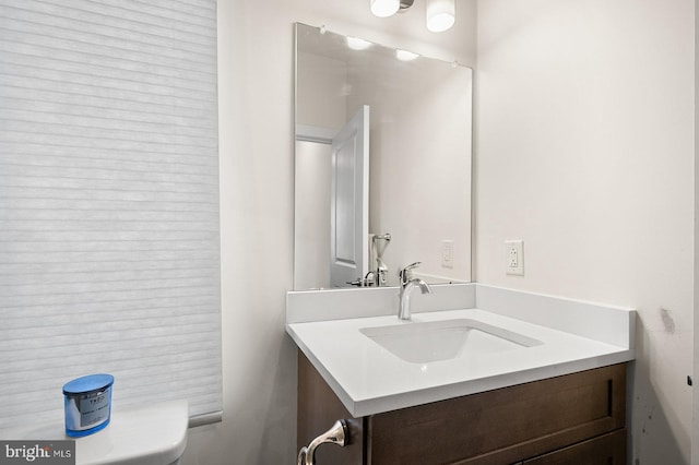 bathroom with toilet and vanity