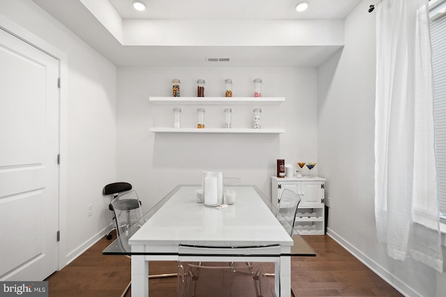 home office with dark hardwood / wood-style floors