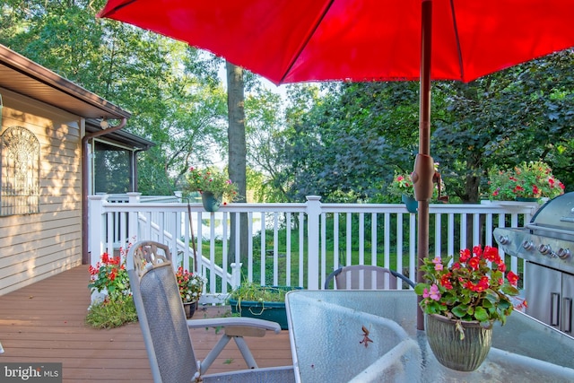 wooden terrace featuring outdoor dining area