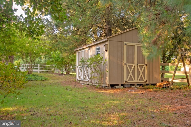 view of shed featuring fence