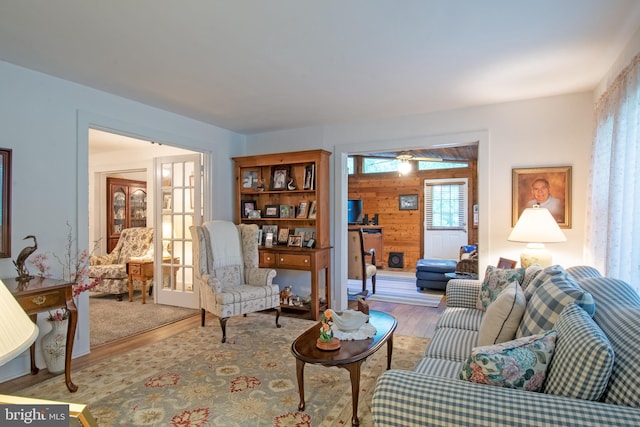 living room featuring wooden walls and light hardwood / wood-style flooring