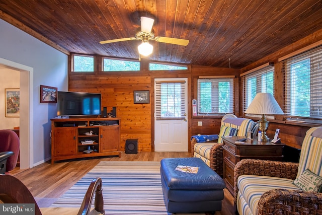 living room with light wood-style floors, lofted ceiling, and a healthy amount of sunlight