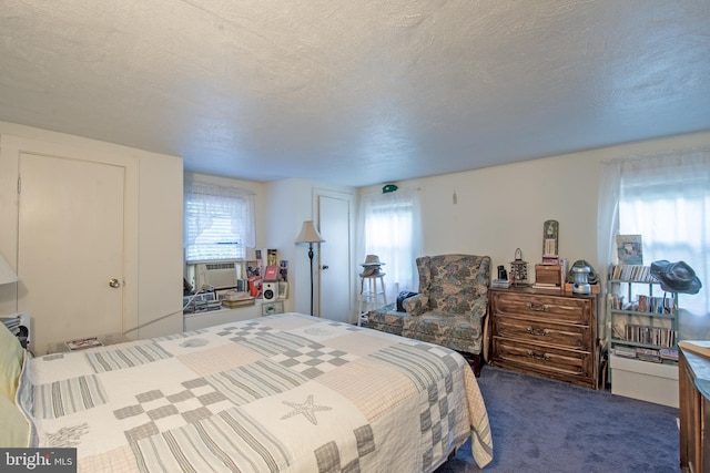 carpeted bedroom featuring a textured ceiling and cooling unit