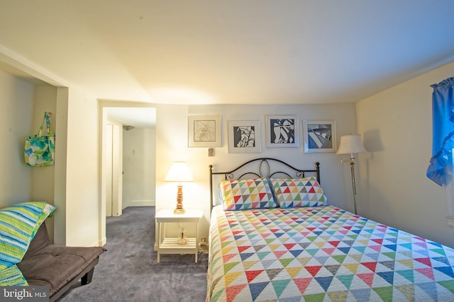 bedroom featuring dark carpet