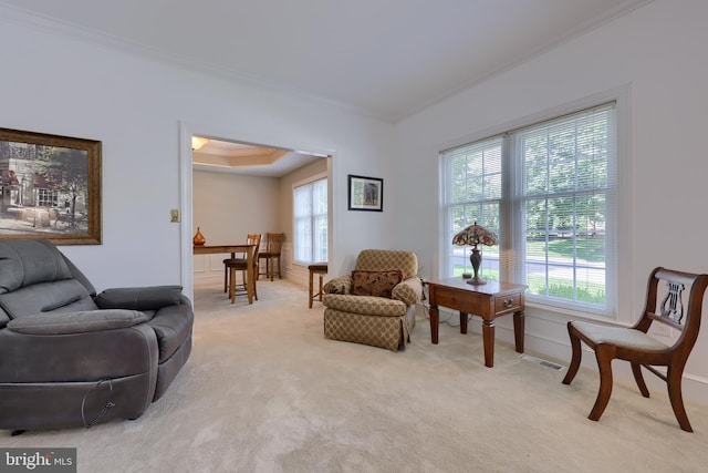 living room featuring ornamental molding and light carpet