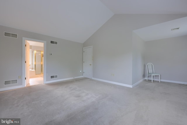 carpeted empty room featuring lofted ceiling