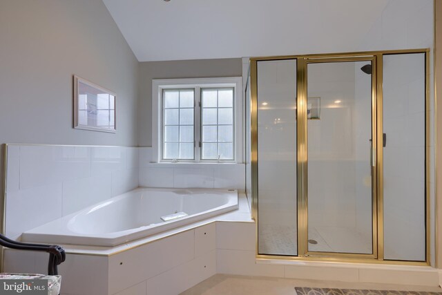 bathroom featuring vaulted ceiling and shower with separate bathtub