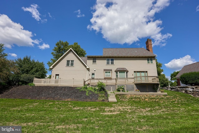 back of property featuring a yard and a deck