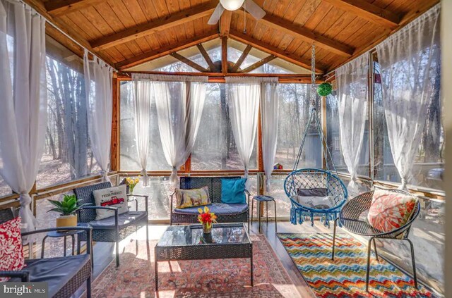 sunroom / solarium featuring a wealth of natural light, lofted ceiling with beams, and wood ceiling