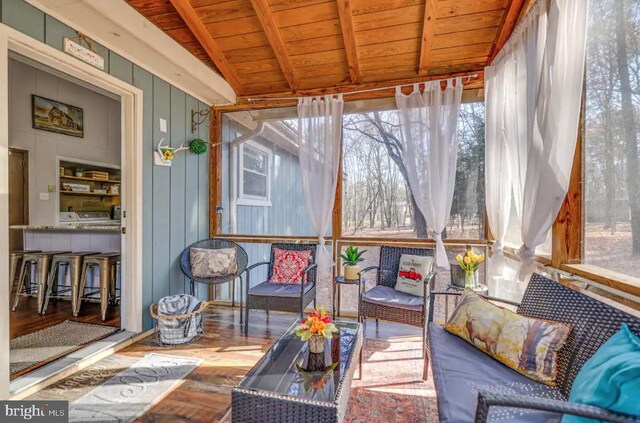 sunroom with wooden ceiling and lofted ceiling with beams