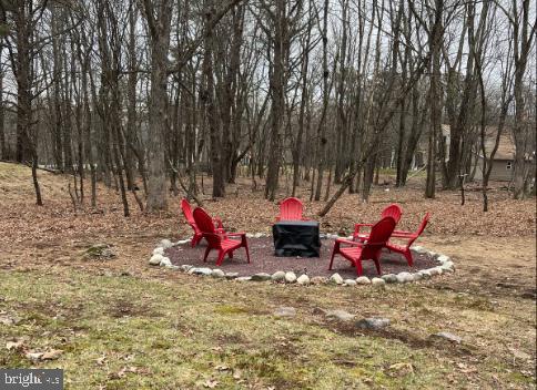 view of yard with an outdoor fire pit