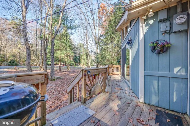 wooden deck featuring a grill