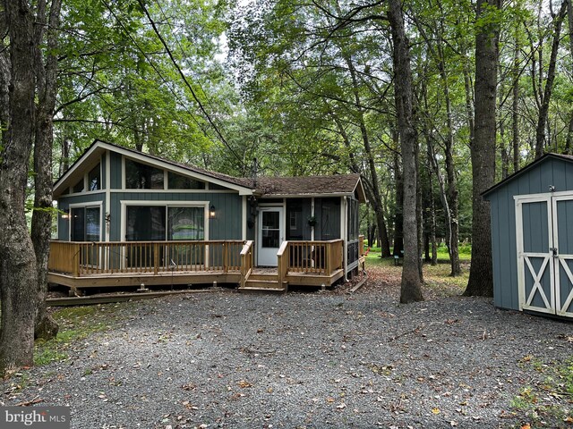 view of front of home featuring a storage shed and a wooden deck