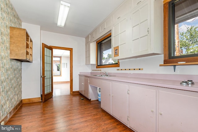 kitchen featuring light countertops, a healthy amount of sunlight, white cabinetry, and light wood-style floors