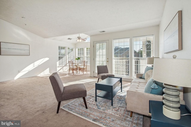 interior space with ceiling fan and light carpet