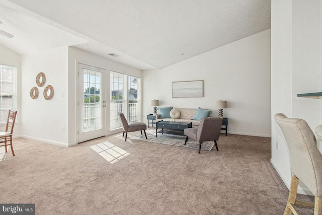 living room featuring vaulted ceiling and light colored carpet